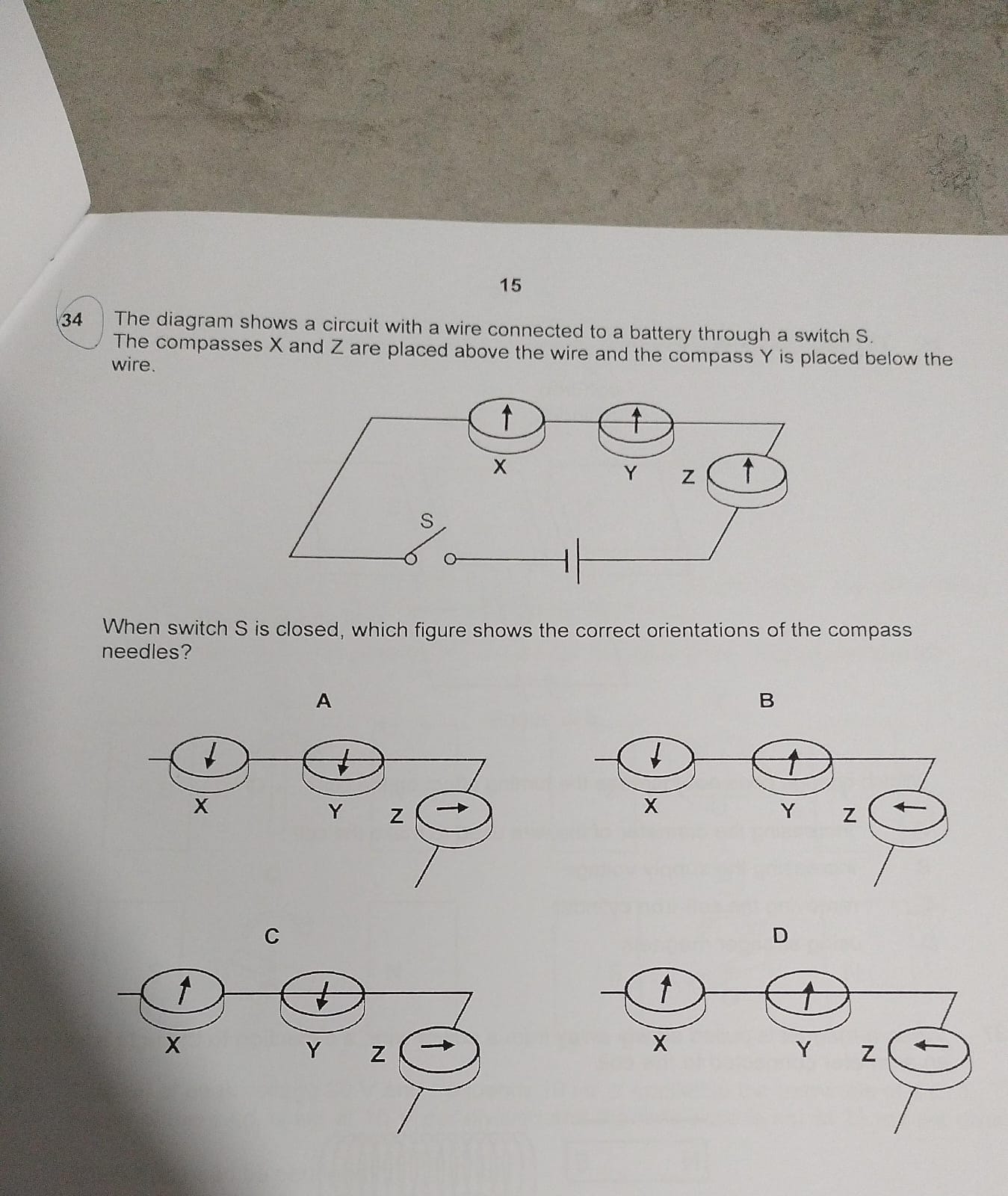 15 34 The diagram shows a circuit with a wire connected to a battery ...