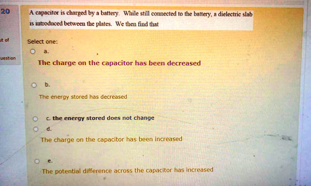 SOLVED: A capacitor is charged by a battery. While still connected to ...