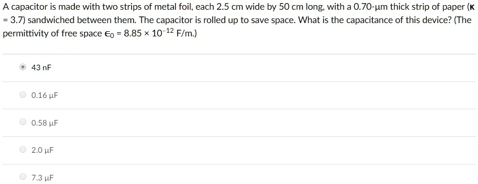 A capacitor is made with two strips of metal foil, each 2.5 cm wide by 50 cm long, with a 0.70-